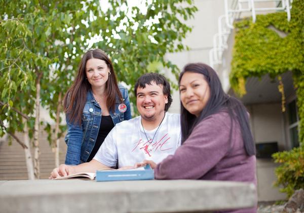 Smiling male and female students on campus