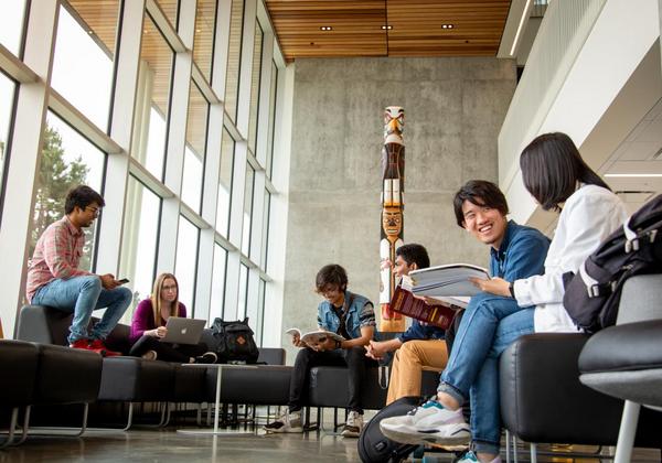 Male and female students hanging out together inside