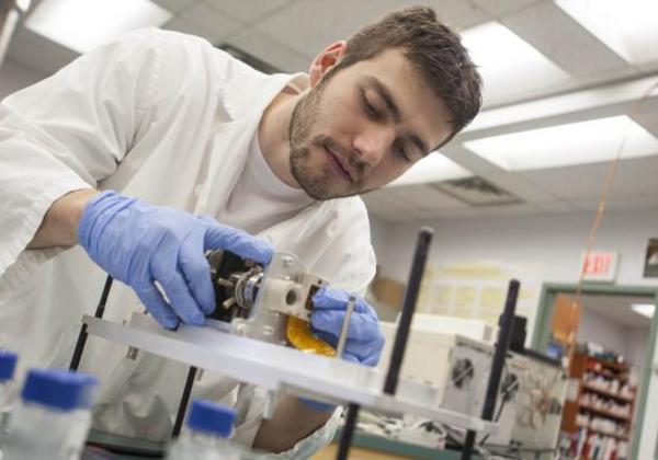 Young male student working in a science lab