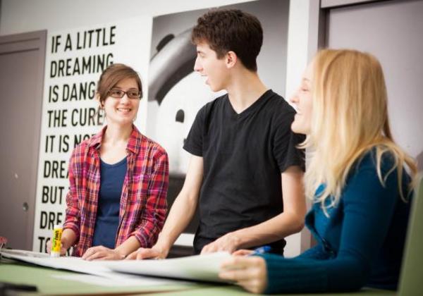 Smiling students working together in class