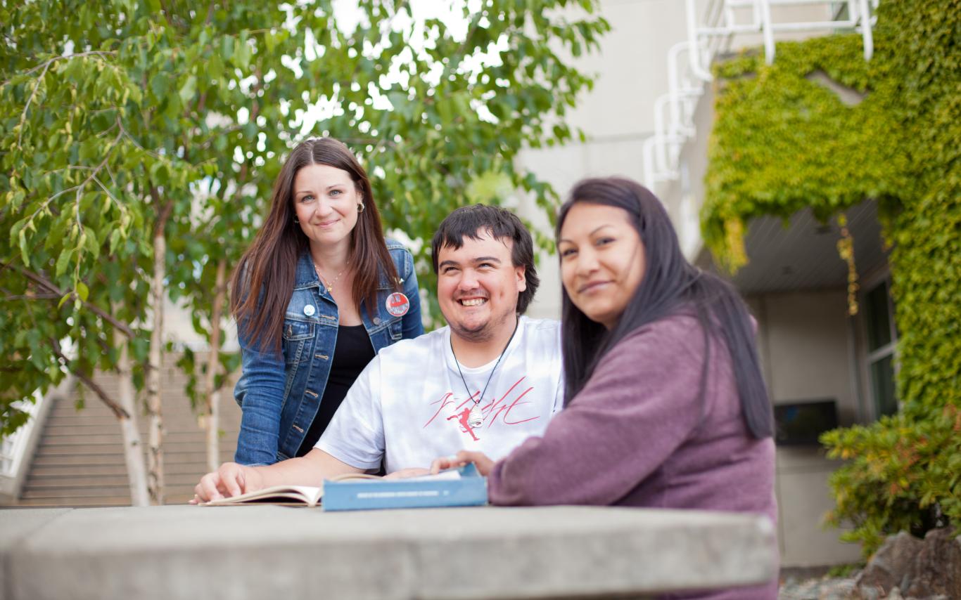 Three mature students, two women and one man.
