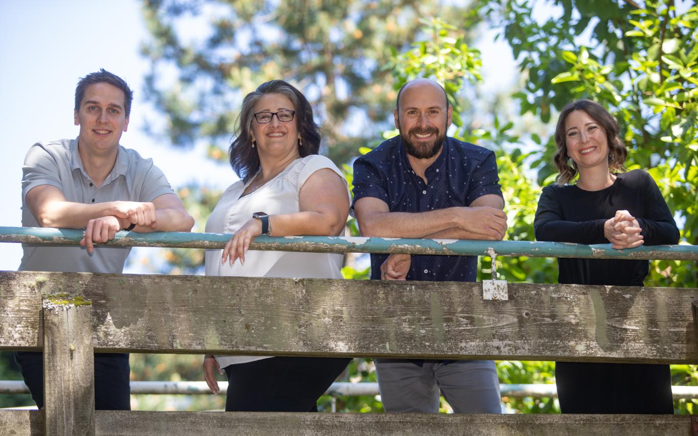 four happy recruiters by a railing